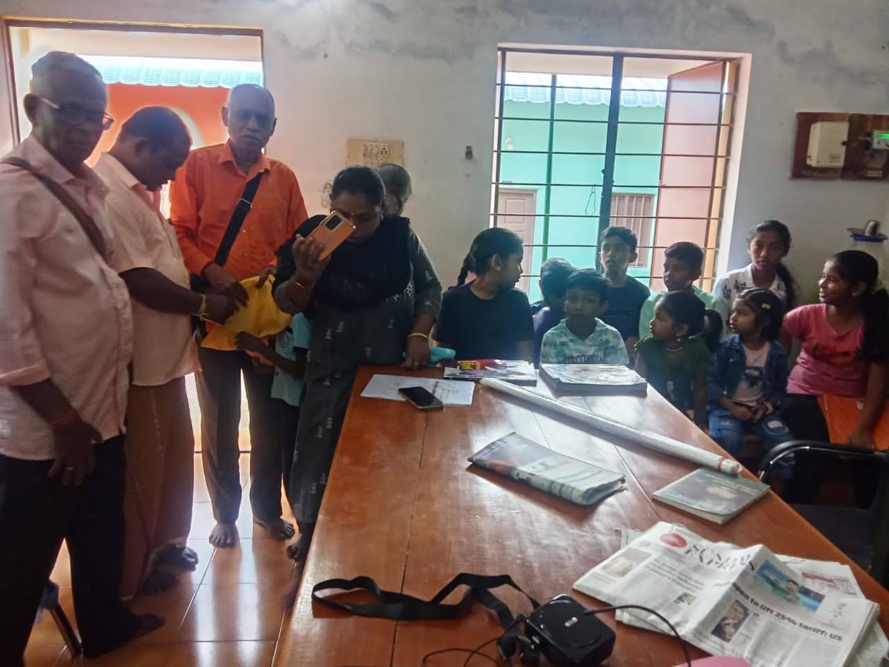 Thanithiramai team engaging with families and children in the community